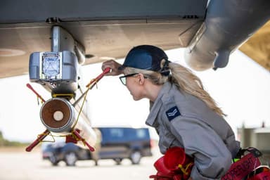 Service person performing maintenance on plane